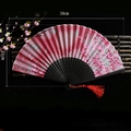 Pink gradient Chinese folding fan with flower pattern, black carved ribs and red tassel - Blossoming Flowers (Red)