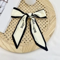 Elegant ivory skinny scarf with black trim and Blind For Love text tied in a bow - Beige Blind for Love