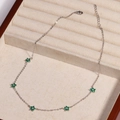 Macro view of silver-plated necklace with green flowers and crystal embellishments - Green Flower - Platinum
