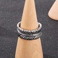 Vintage silver feather ring with detailed textures on a wooden stand in punk style - US 8 / Silver