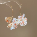 Detailed shot of gold branch earrings with floral fabric petals and pearl stamen accents - Silver Earring Post - Gold Style / Orange