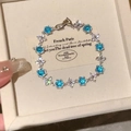 Elegant floral silver bracelet with round blue crystals and micro-inlaid zircon petals - Blue Zirconia Splicing Style / Blue