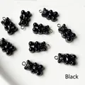 Macro view of black resin gummy bear pendants with metal loops for DIY jewelry making - Black