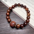 Polished Black Rosewood bead bracelet featuring an engraved Fu fortune barrel charm - 10mm Bead With Carved Luck Symbol