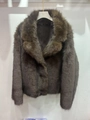 Detail shot of a coffee brown faux fur jacket featuring long sleeves and a wide lapel collar - XS / Dark Brown