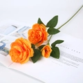 Artificial orange Persian Buttercup spray with two blooming flowers and one bud on a magazine - 3 Heads / Orange