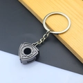Macro detail of gunmetal zinc alloy rotor engine keychain with flat key ring - Rotary Rotor / Black