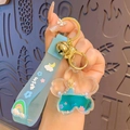 Blue flower shaped liquid keychain with fairy charm and silicone wish hand strap - Liquid Sakura Butterfly Princess - Blue