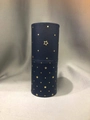 Detail view of dark blue cylindrical makeup brush holder with gold star pattern - Blue Stars Bucket
