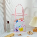 Detail view of pink transparent PVC tote bag with cute dog print on a sunlit table - Pink Dog