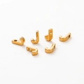 Macro shot of 6 polished gold-plated J-shaped alphabet beads for DIY jewelry making - Letter J / Gold