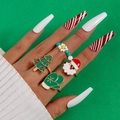 Christmas rings set featuring Santa and tree charms on a festive green background - Christmas 4-Piece Set (25664)