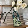 Detail of green knitted crossbody phone bag with Spring text and swallow embroidery - Spring Swallow - Phone Bag