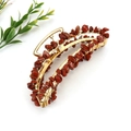 Detail of red natural stone beads hand-wrapped on a golden metal banana hair claw clip - Gold + Red Stone