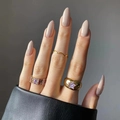 Three gold rings featuring purple star gemstone and colorful crystals on manicured fingers - Apricot/Nude (JP2141)