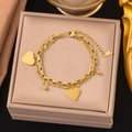 Double-layered gold heart bracelet with small round beads on a luxury jewelry gift box - Double Peach Heart Gold