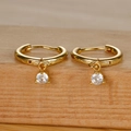 Detailed macro view of gold-plated hoop earrings featuring sparkling round cubic zirconia drops - Gold White Zircon