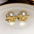 Elegant gold butterfly and white pearl stud earrings on a white ceramic plate - 59# Gold & White Pearl Butterfly