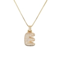 Detail of gold bubble letter E necklace with sparkling pavé cubic zirconia stones - Letter E