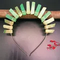 Detailed view of green crystal stones hand-wrapped with silver wire on a luxury bridal headband - Green Aventurine