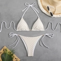 Detail of white crochet bikini set with halter top, side ties and elegant pearl accents - White