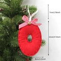 Red felt Christmas number 0 ornament with plaid bow and gold bell hanging on a tree - O-Bell