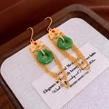 Macro view of gold ear hooks with green jade-like circle and elegant chain tassels - Chinese Retro Tassel Safety Buckle (Ear Hook)