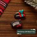 Pair of red Christmas gift box hair clips for cats and dogs on wooden background - Christmas Gift Black Clip