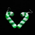 Macro view of Christmas candy cane earrings in green and white stripes forming a heart shape - Green Candy Cane Earrings