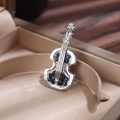 Silver violin brooch with deep blue gemstones in a beige jewelry gift box - Silver Base Blue Rhinestone