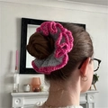 Handmade crochet hair scrunchie in gray yarn with bright pink ruffled edges worn by model - Grey with Red Edge