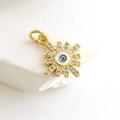 Macro detail of gold plated evil eye sunflower pendant with sparkling zircons - Sunflower Evil Eye