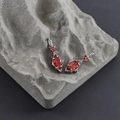 Detailed macro view of red marquise-cut gems with silver metal accents on stone - Silver Base - Red Zircon