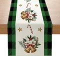 Polyester Christmas table runner with bells and holly pattern on a wooden dining table - Black Green Gingham & Bells