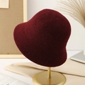 Detail of burgundy wool bucket hat on a gold stand with an elegant autumn aesthetic - M (56-58cm) / Burgundy