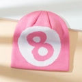 Pink knitted beanie with white circular patch and number 8 graphic on a neutral background - M (56-58cm) / Pink & White
