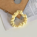 Pale yellow satin scrunchie with smooth pleated texture for stylish ponytail styling - Light Yellow