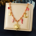 Close-up of bohemian woven necklace with gold sun, moon and red chili pendants - Orange Rope Sun Face Multi Element Style (N3786)