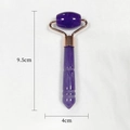Purple resin facial roller massager with rose gold frame measuring 9.5cm by 4cm - Purple