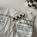 Detail of a black and white checkerboard wavy hair clip made of smooth acrylic material - 11# Duckbill Clip - Long Wave
