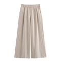 Close-up of light oatmeal linen wide-leg pants featuring elastic drawstring waistband - XS / Apricot Pants