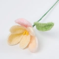 Close-up of handmade crochet mohair tulip flower with soft yellow and pink yarn texture - Mohair Tulips - Yellow Series