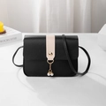 Black mini crossbody bag with cream contrast strap, gold buckle, and pearl pendant - Black