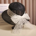 Elegant black straw sun hat for women featuring a large white lace bow and pearl trim - Black