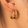 Polished gold double-hoop C-shaped stainless steel earrings worn by a model - Side-by-Side Double Hoops (BJGE0710)