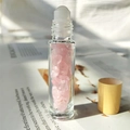 Clear glass essential oil roller bottle filled with pink rose quartz and wooden lid - Rose Quartz