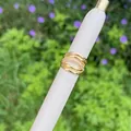Macro shot of 18K gold plated multi-layer intertwined ring with shimmering zircon stones - Multi-circle Intertwined Pave Style
