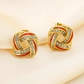 Macro shot of gold-plated twisted earrings with red enamel and pavé rhinestones - Spiral Knot Style (KE115089-K)