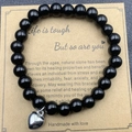 Handmade black onyx beaded bracelet with silver heart charm on brown gift card - Polished Black Heart With Card