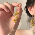 Detailed close-up of yellow acrylic floral tassel earrings featuring multi-layered flower petals - 2# Ear Hook-Gold-Yellow